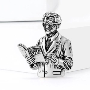Vintage silver professor brooch featuring a scholar reading a book for clothing