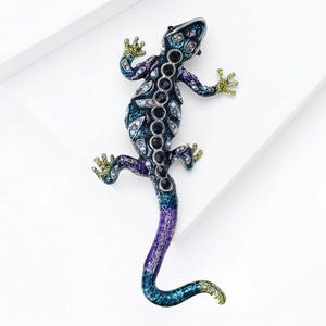 Detailed view of enamel lizard brooch with gradient purple blue tones and colorful rhinestones