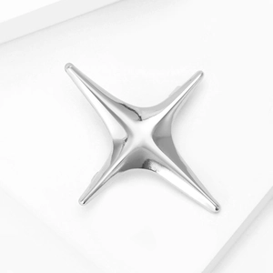 Polished silver four-pointed star brooch for women in a minimalist modern jewelry style