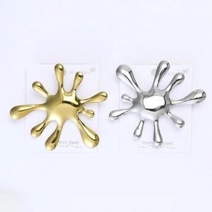 Polished stainless steel water splash brooches in gold and silver set on a display card
