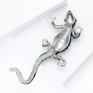 Detail view of the silver-plated lizard brooch back with secure safety pin clasp
