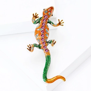Exquisite enamel lizard brooch with colorful rhinestones on a white geometric stand