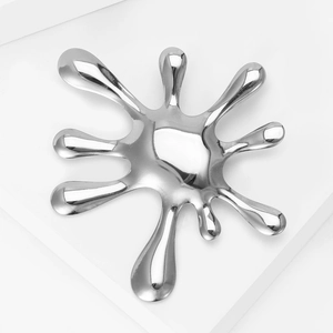 Minimalist silver splash water droplet brooch with mirror polished finish on white background