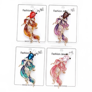 Detail view of four colorful enamel goldfish brooches with pearls and crystals in 2x2 grid