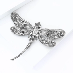 Detailed back view of silver dragonfly brooch showing pin clasp and hollowed wings