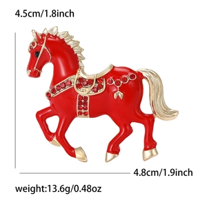 Detailed size view of red enamel horse brooch with sparkling rhinestones and gold plating
