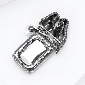 Detail view of the vintage parrot brooch back with pin clasp and crystal inlay