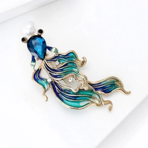 Detail of goldfish brooch with blue-green enamel, crystals and pearl on gold base