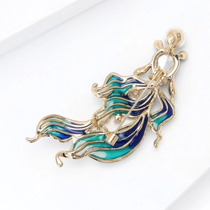 Detailed close-up of gold-plated goldfish brooch with blue and green enamel drip glaze