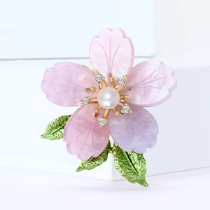 Luxury cherry blossom brooch with pink resin petals, pearl center, and green enamel leaves