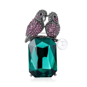 Elegant parrot brooch with green emerald glass, purple rhinestones and pearl detail