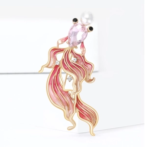 Elegant goldfish brooch with pink gradient enamel and crystals on a white pedestal