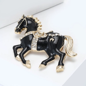 Close-up of black enamel horse brooch with sparkling rhinestones and gold-plated details