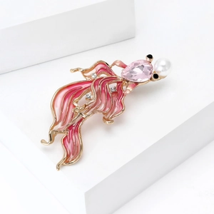Detailed view of goldfish brooch featuring pink enamel and large water drop crystal