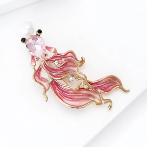 Detail of goldfish brooch featuring pink enamel gradient and sparkling water-drop crystal