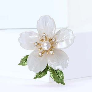 Elegant white enamel flower brooch with green leaves and pearl center in gold plating