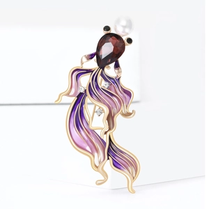 Detail of goldfish brooch with red gemstone, pearl accent and purple enamel tail
