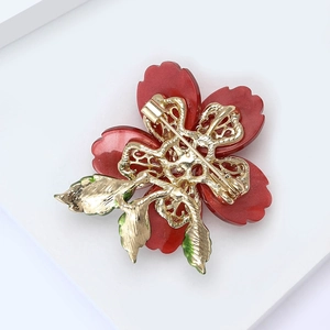 Detail view of flower brooch back showing golden alloy base and secure pin clasp mechanism