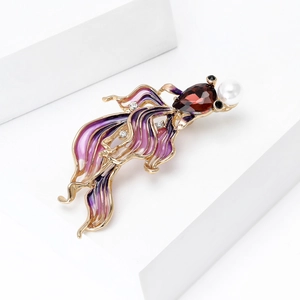 Detailed close-up of a goldfish brooch with purple enamel, red gems and a white pearl