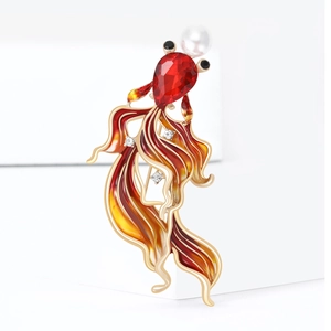 Close-up of goldfish brooch featuring red crystal teardrop and enamel tail detail