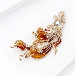 Detailed back view of gold goldfish brooch showing rotary safety pin and red enamel