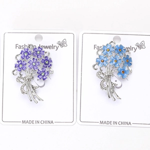 Detail of enamel hydrangea brooches with sparkling rhinestones and ribbon bow accents