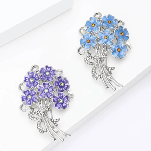 Detail of floral brooch with enamel petals, sparkling rhinestones and crystal bow decoration