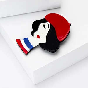 Fashionable acrylic brooch featuring a lady in red beret on a clean geometric stand
