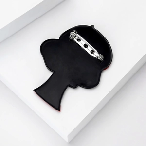Close-up of the back of a fashion acrylic silhouette brooch with secure silver metal pin