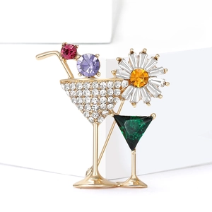 Detail of cocktail glass brooch with inlaid rhinestones and colorful gemstones