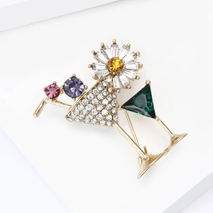 Detailed view of cocktail glass brooch with colorful rhinestones and gold alloy base