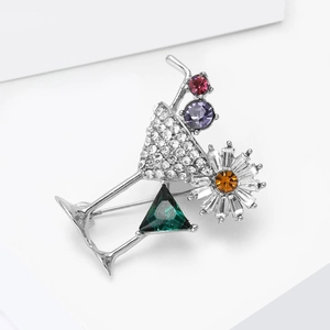 Close-up of cocktail glass brooch with colorful gemstones and white zircons