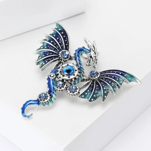Detailed steampunk dragon brooch with blue enamel wings and mechanical gear center