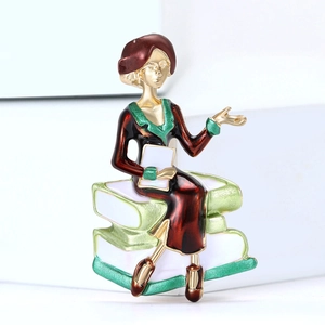 Detail view of female teacher brooch with colorful enamel finish on white background