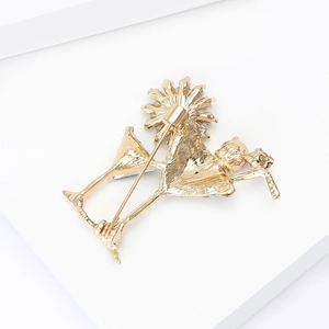 Detailed back view of a golden cocktail glass brooch showing secure pin fastener texture