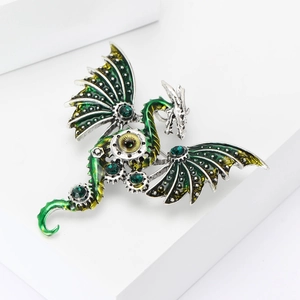 Detail of mechanical dragon brooch with green rhinestones and punk gear eye element