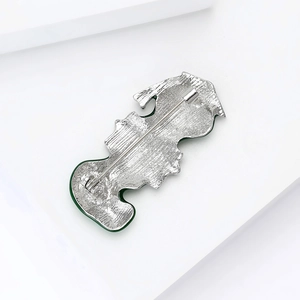 Detail view of the silver metal back and safety clasp of the violin enamel brooch