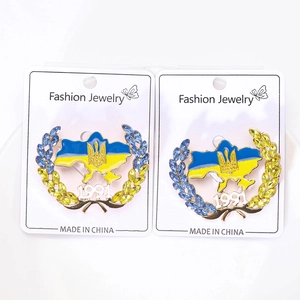 Detail of Ukraine map brooch set with blue and yellow enamel and sparkling rhinestones