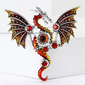 Macro shot of steampunk dragon brooch with gear details and red gemstone inlays