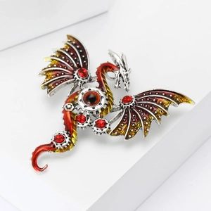 Close-up of steampunk mechanical dragon brooch with red enamel and gear detailing
