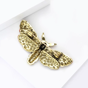 Detail of vintage gold moth brooch showing back texture and rotating safety pin clasp