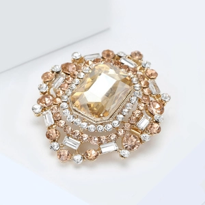 Macro shot of luxury brooch with large champagne crystal and pavé rhinestones