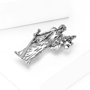 Gros plan d'une broche Lady Justice en argent vintage montrant les détails de la balance