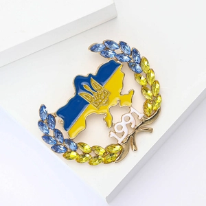 Macro shot of Ukraine map pin with blue yellow enamel, rhinestones and 1991 detail