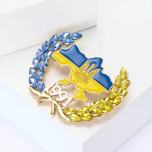 Detailed view of the Ukraine map brooch with blue and yellow crystals and 1991 year mark