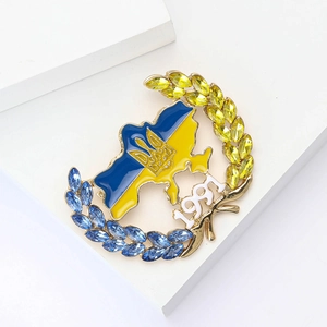 Macro detail of Ukraine map brooch with blue and yellow crystals and 1991 engraving