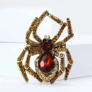 Vintage gold spider brooch with vibrant red crystals and orange rhinestones for Halloween