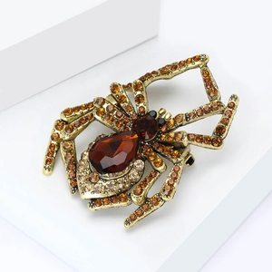 Detailed macro view of vintage spider brooch with brown crystals and golden rhinestones