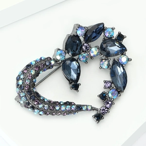 Macro shot of gun-black alloy heart brooch with deep blue rhinestones and AB aurora crystals