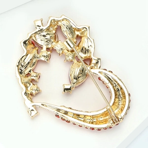 Detailed back view of gold alloy heart brooch showing the pin fastening and red rhinestones